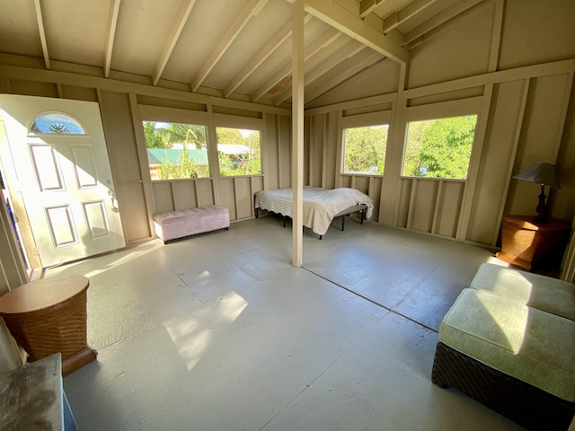 interior space with vaulted ceiling and multiple windows