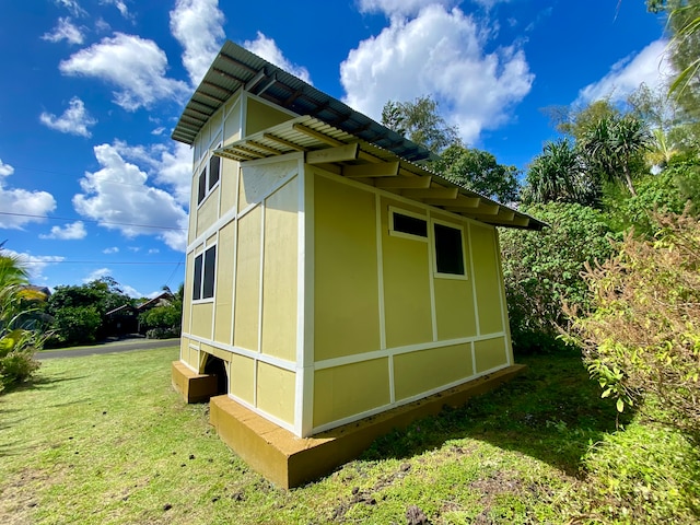 view of side of property with a lawn