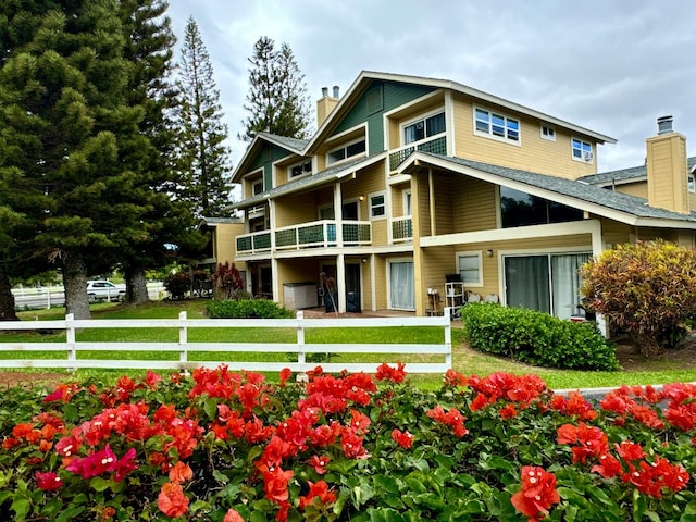 exterior space with a yard and a balcony