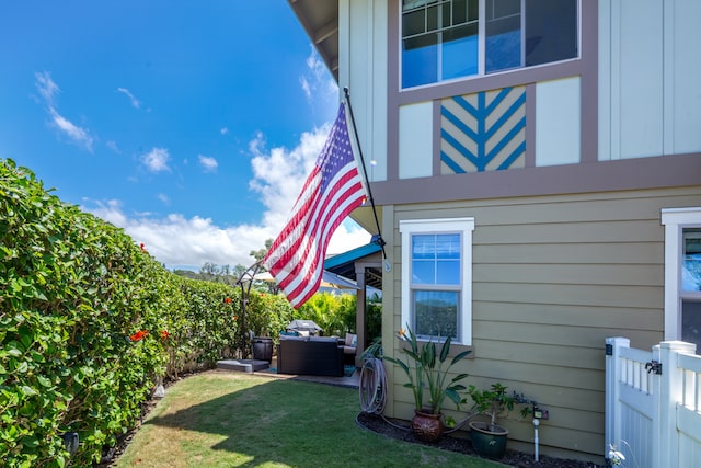 view of property exterior featuring an outdoor hangout area and a lawn