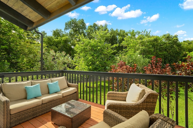 wooden deck featuring a lawn and outdoor lounge area