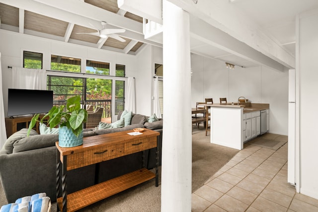 tiled office featuring ceiling fan, sink, and lofted ceiling with beams