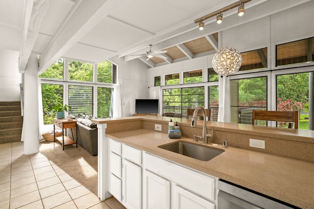 kitchen featuring vaulted ceiling with beams, white cabinetry, sink, ceiling fan, and stainless steel dishwasher