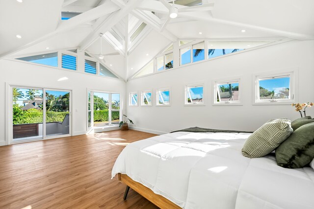 bedroom featuring ceiling fan, high vaulted ceiling, access to exterior, and hardwood / wood-style floors