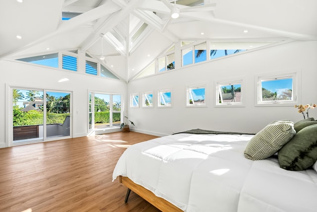 bedroom featuring high vaulted ceiling, wood finished floors, baseboards, access to exterior, and beam ceiling