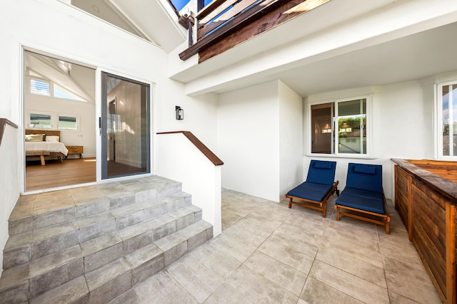 property entrance featuring a patio and stucco siding