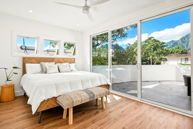 bedroom featuring ceiling fan, light wood-type flooring, and access to outside