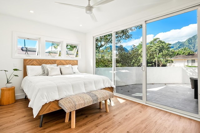 bedroom featuring light wood-style flooring, a mountain view, recessed lighting, a ceiling fan, and access to outside