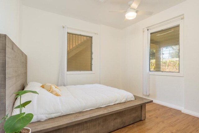 bedroom with ceiling fan and light hardwood / wood-style floors