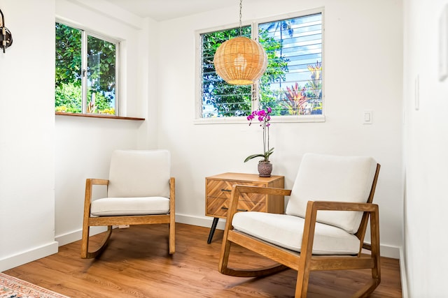 living area featuring light wood-type flooring and baseboards