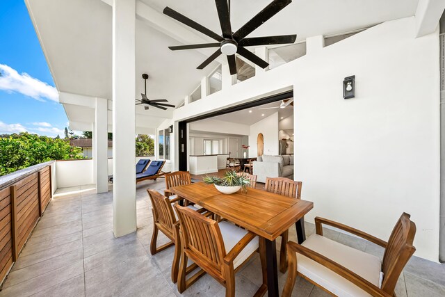 dining room featuring ceiling fan, high vaulted ceiling, and light tile patterned floors