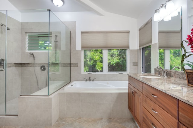 bathroom featuring a wealth of natural light, vanity, independent shower and bath, and vaulted ceiling