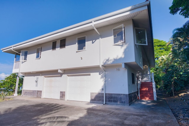 rear view of property with a garage