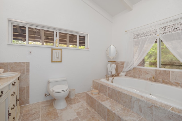 bathroom featuring tiled bath, tile patterned flooring, toilet, and vanity