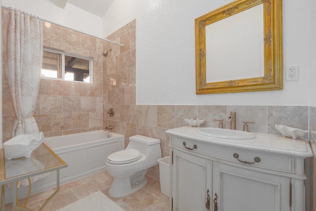 full bathroom with toilet, tile patterned flooring, vanity, tile walls, and tiled shower / bath