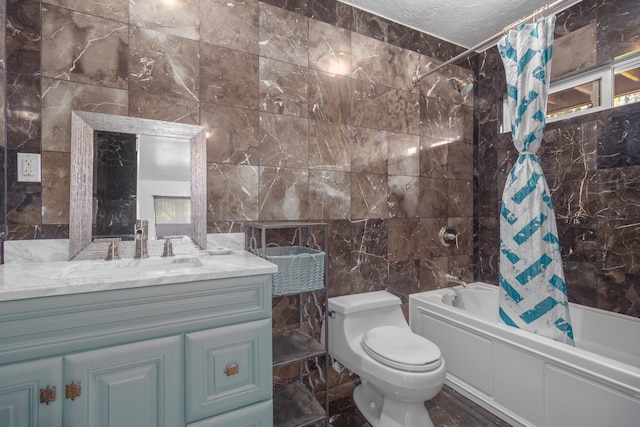 full bathroom featuring shower / bath combination with curtain, a textured ceiling, vanity, tile walls, and toilet