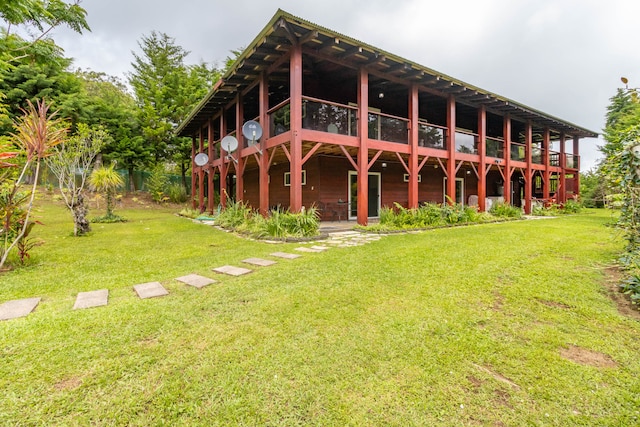 rear view of property with a lawn