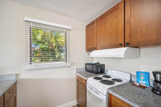 kitchen with white range with electric stovetop and a textured ceiling