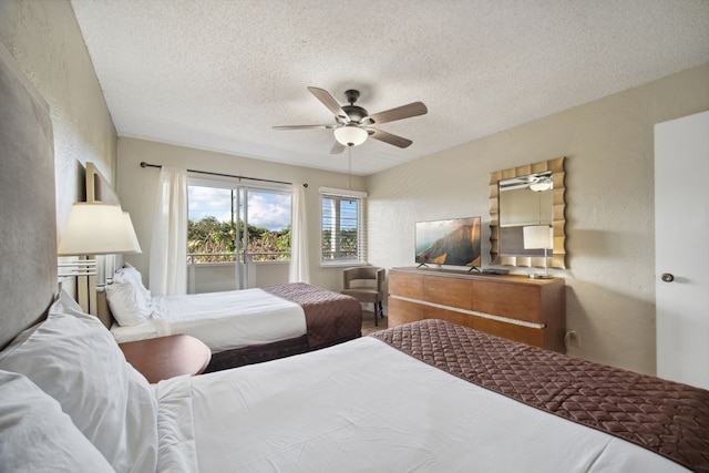 bedroom with ceiling fan, hardwood / wood-style flooring, and a textured ceiling