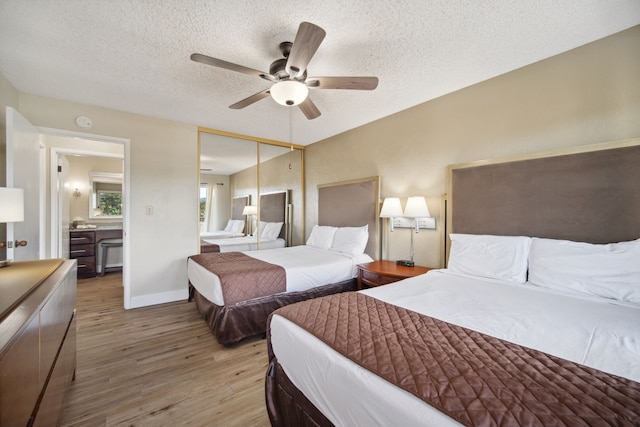 bedroom featuring a textured ceiling, hardwood / wood-style flooring, ceiling fan, and a closet