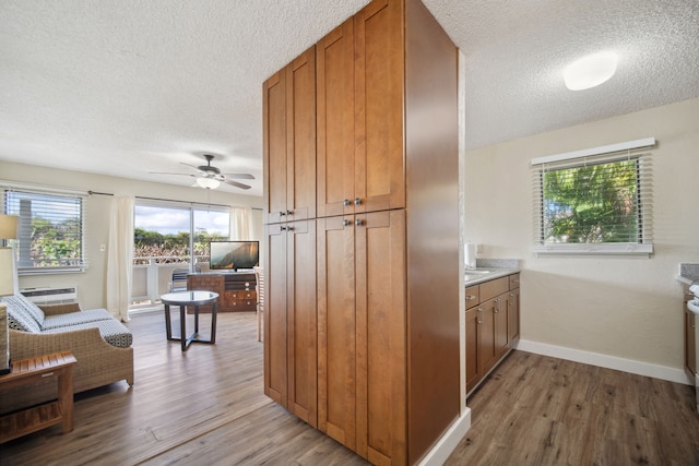 kitchen featuring dark wood-type flooring, a textured ceiling, and ceiling fan