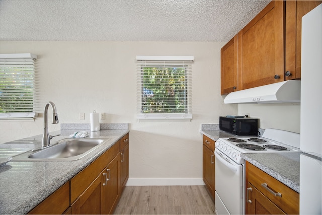 kitchen featuring a textured ceiling, white range with electric stovetop, sink, and light hardwood / wood-style floors