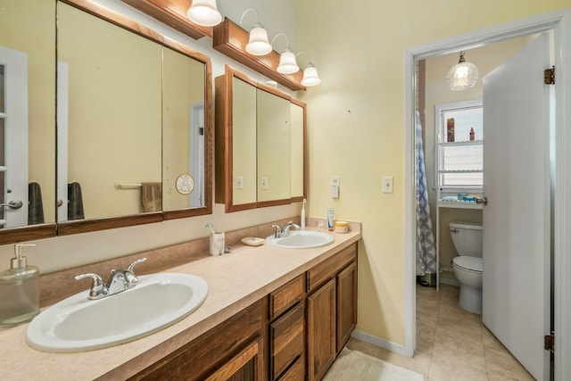 bathroom with vanity, toilet, and tile patterned floors