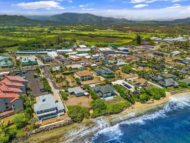 drone / aerial view featuring a water and mountain view