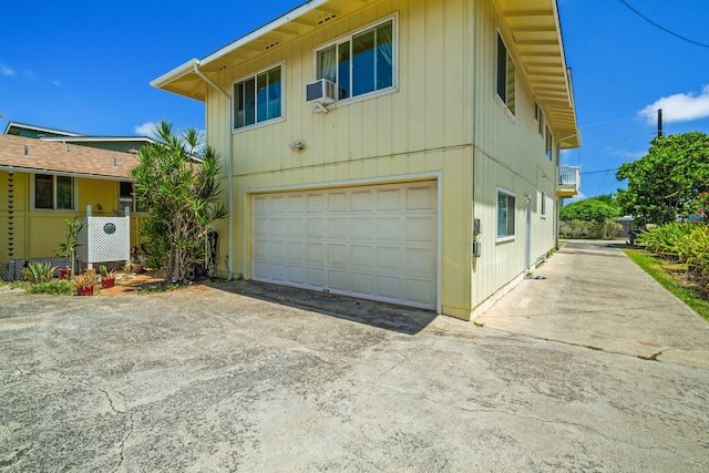 view of front of house featuring a garage and cooling unit