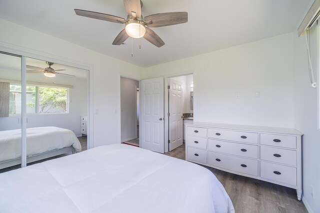 bedroom with connected bathroom, hardwood / wood-style floors, and ceiling fan