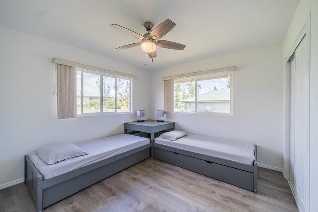 living area featuring ceiling fan and light hardwood / wood-style floors