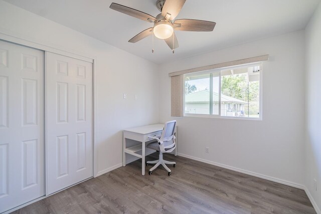 home office with wood-type flooring and ceiling fan