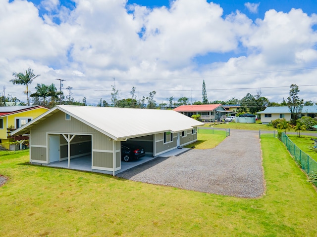 back of property featuring a lawn and an outbuilding