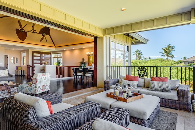 exterior space featuring a chandelier, plenty of natural light, and light tile patterned flooring