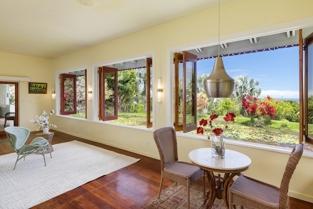 dining room with hardwood / wood-style flooring and a healthy amount of sunlight