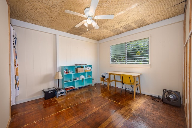 misc room with wood walls, ceiling fan, and dark hardwood / wood-style flooring