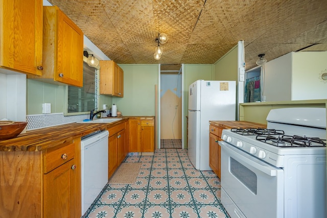 kitchen featuring sink and white appliances