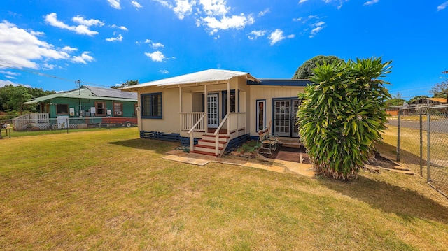 back of property featuring a lawn