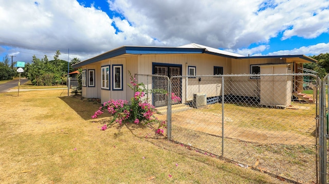 rear view of property with a lawn