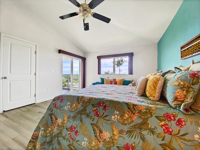 bedroom featuring ceiling fan, light hardwood / wood-style floors, access to exterior, and lofted ceiling