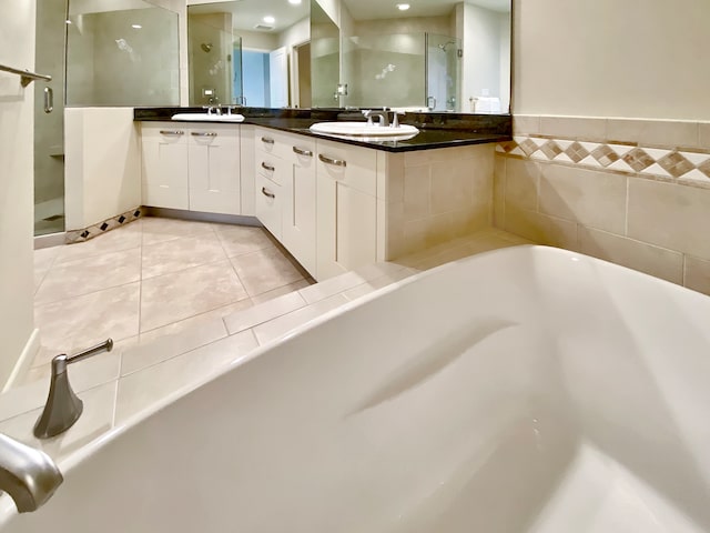 bathroom with independent shower and bath, tile patterned flooring, and vanity