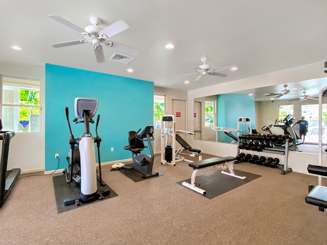 exercise room with ceiling fan and a healthy amount of sunlight