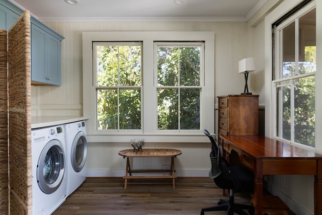 laundry area with washing machine and clothes dryer, cabinets, a wealth of natural light, and dark wood-type flooring