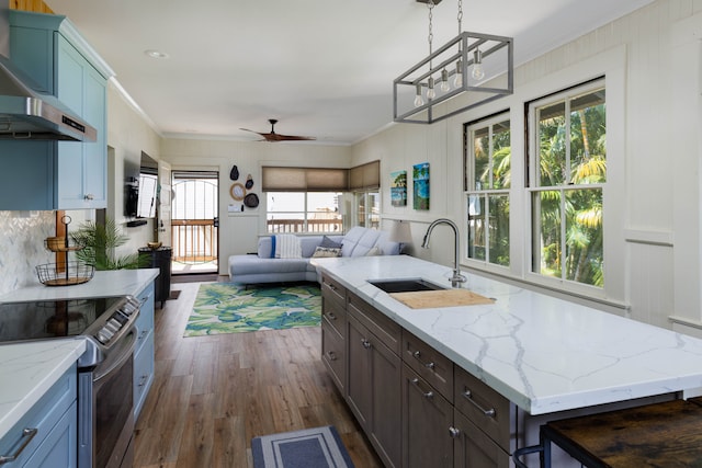 kitchen with a kitchen island, plenty of natural light, extractor fan, and sink