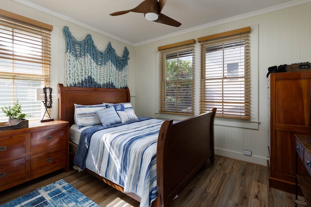 bedroom featuring dark wood-type flooring, wood walls, ceiling fan, and crown molding