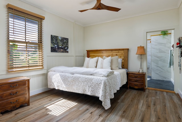 bedroom with crown molding, dark hardwood / wood-style flooring, ceiling fan, and multiple windows