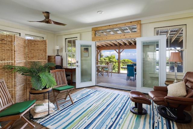 doorway to outside featuring wood-type flooring, ornamental molding, and ceiling fan