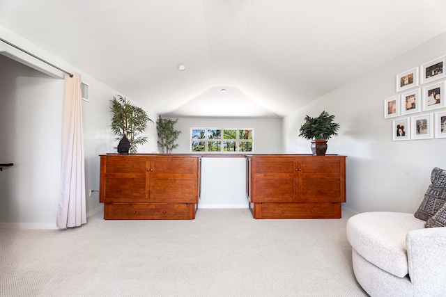 sitting room with lofted ceiling and light colored carpet