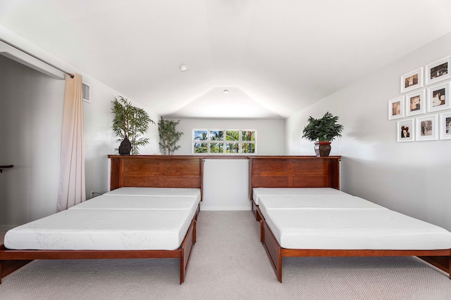 carpeted bedroom featuring vaulted ceiling