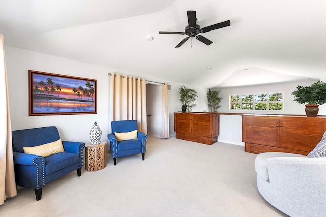 sitting room with vaulted ceiling, light colored carpet, and ceiling fan